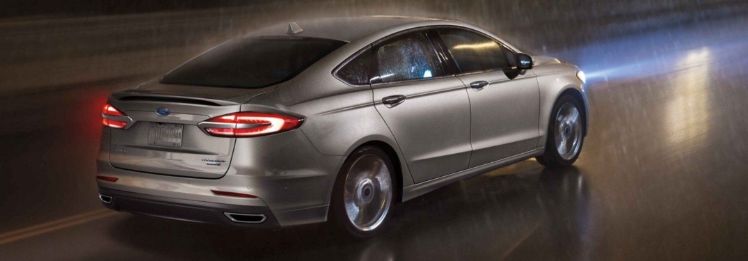 2019 Ford Fusion Titanium in gold back view in the rain