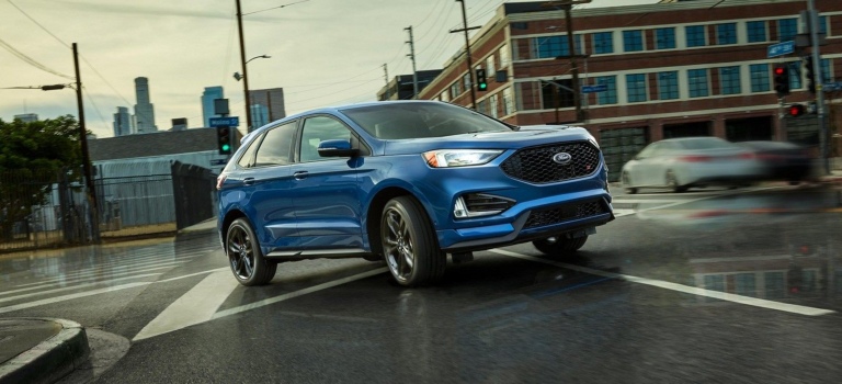 2019 Ford edge ST blue side view turning a corner