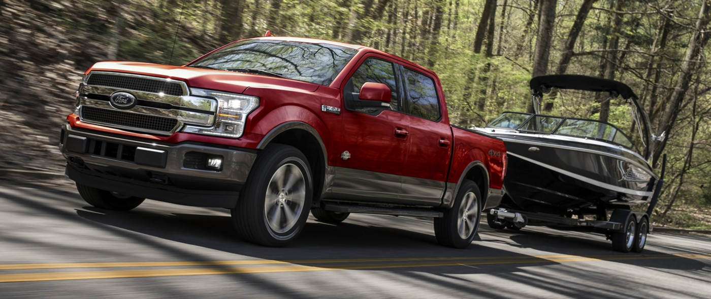 Red Ford F-150 towing a boat