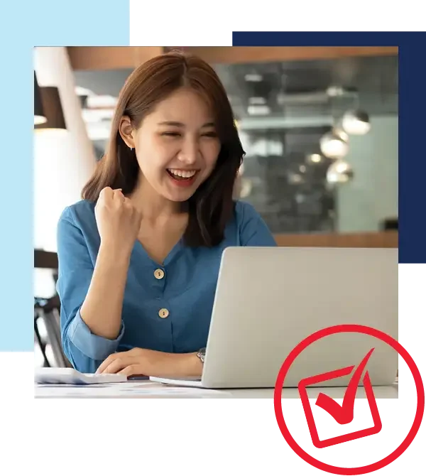 Financing with Holiday Ford is fast and easy! Image of asian woman making a fist pump while smiling at her laptop.