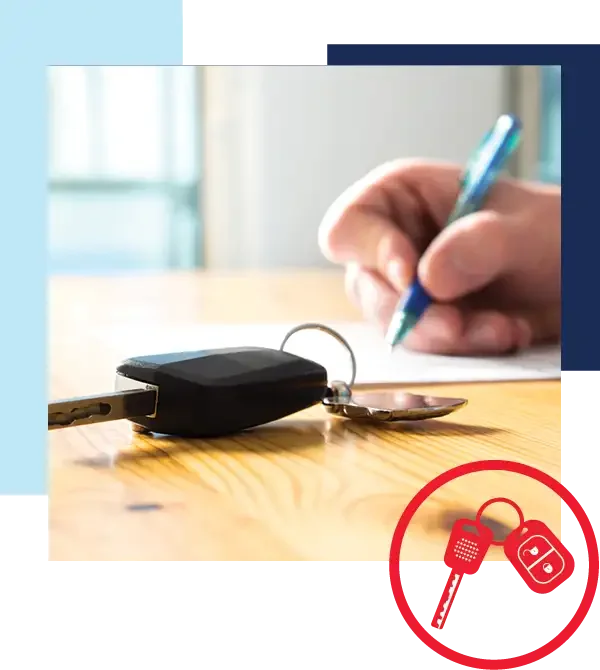 Reduce your monthly payments by trading in your current vehicle. Image of hand signing document on wooden desk with car keys in front.